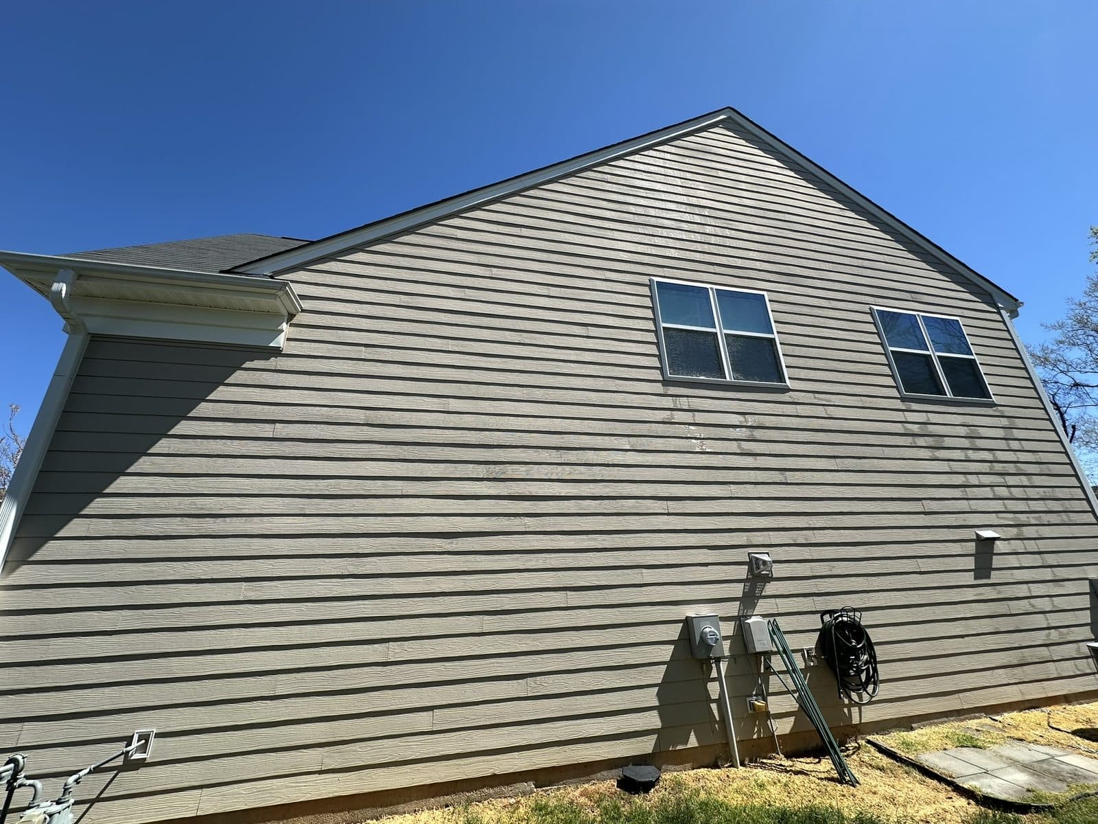 Two-story home soft-washed clean — the kind of result Jump 2 It delivers in High Point, NC