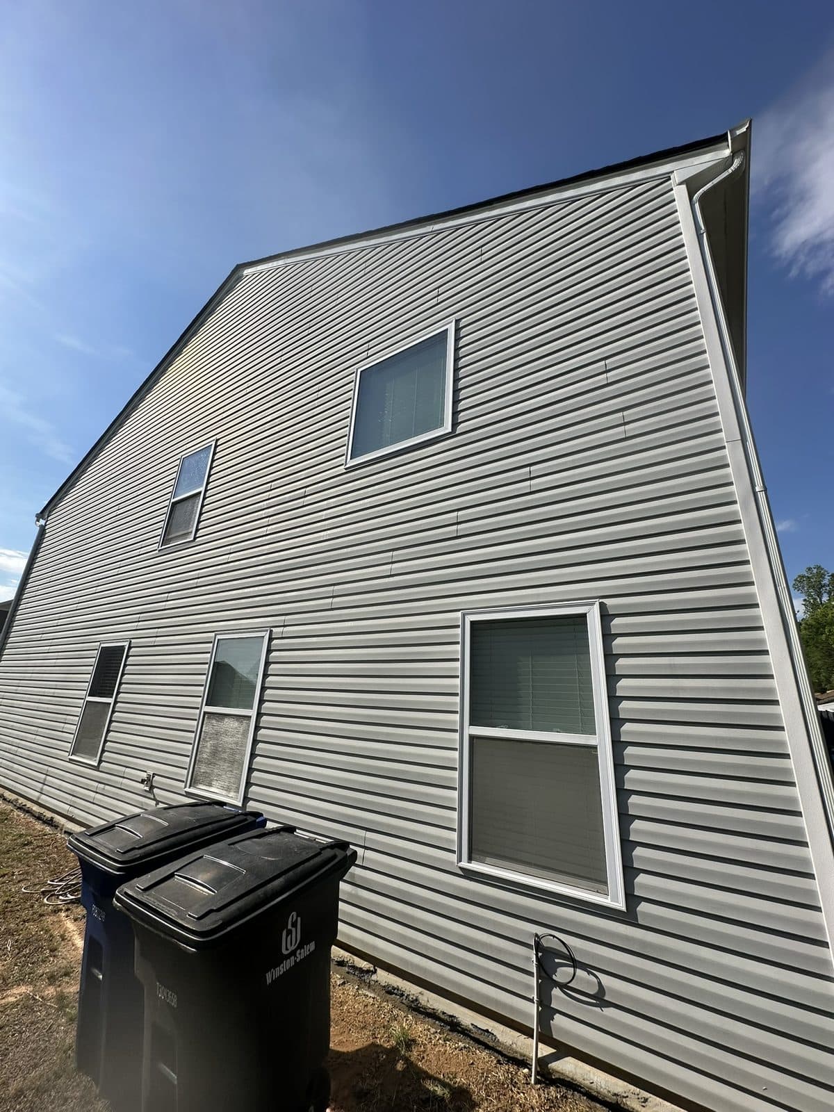 Freshly cleaned home exterior and driveway — the result Jump 2 It delivers in Kernersville, NC